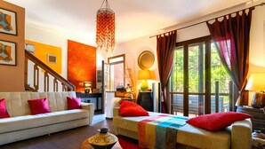 A modern living room with a sofa, a bed, a coffee table, and a view of the outdoors. - Apartment In A Hotel 'Bnb Sottosopra Intero 8 Pax' with Sea View, Shared Terrace and Wi-Fi (Gallipoli)