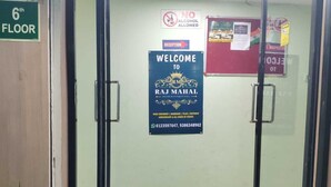 A hotel entrance with a reception desk, a welcome sign, a no alcohol allowed sign, and a floor sign indicating the 6th floor. - Raj Mahal Rooms & Banquet Hall (Patna)