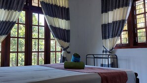 Una habitación con cama, radiador y cortinas.
