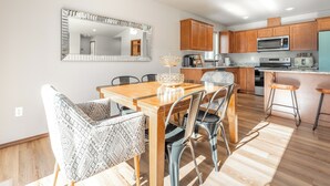 A modern kitchen with wooden cabinets, a stainless steel microwave, and a built-in oven. - Hendrix Hideaway on Rock Island Golf Course! (Rock Island)