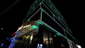 A hotel with a modern design, featuring a prominent sign with illuminated letters. - Alion Hotel (Izmir)