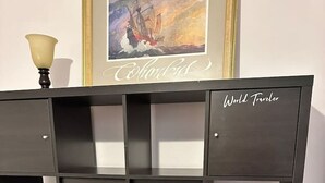 A black metal shelving unit with multiple compartments, labeled "World Traveler." - Travelers Palm Beachy Paradise (Edgewater)