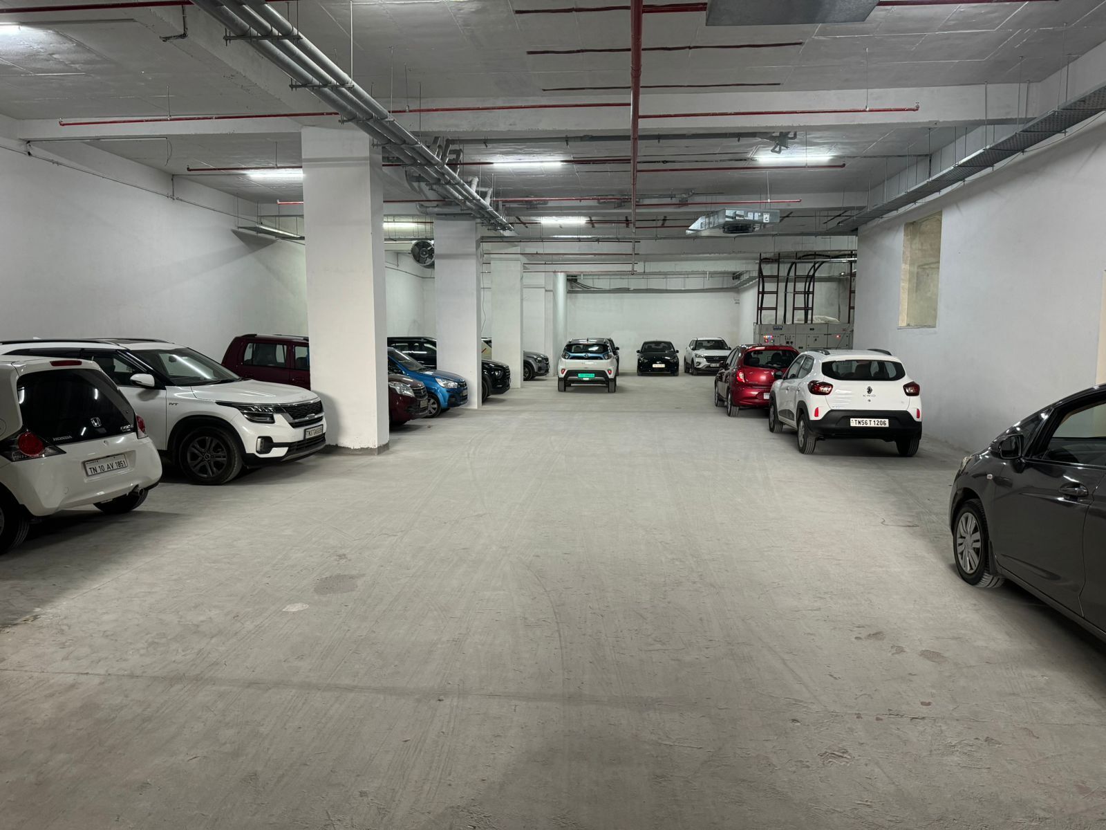 A multi-level parking garage with several cars parked on different levels.