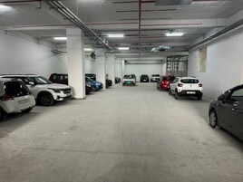 A multi-level parking garage with several cars parked on different levels.