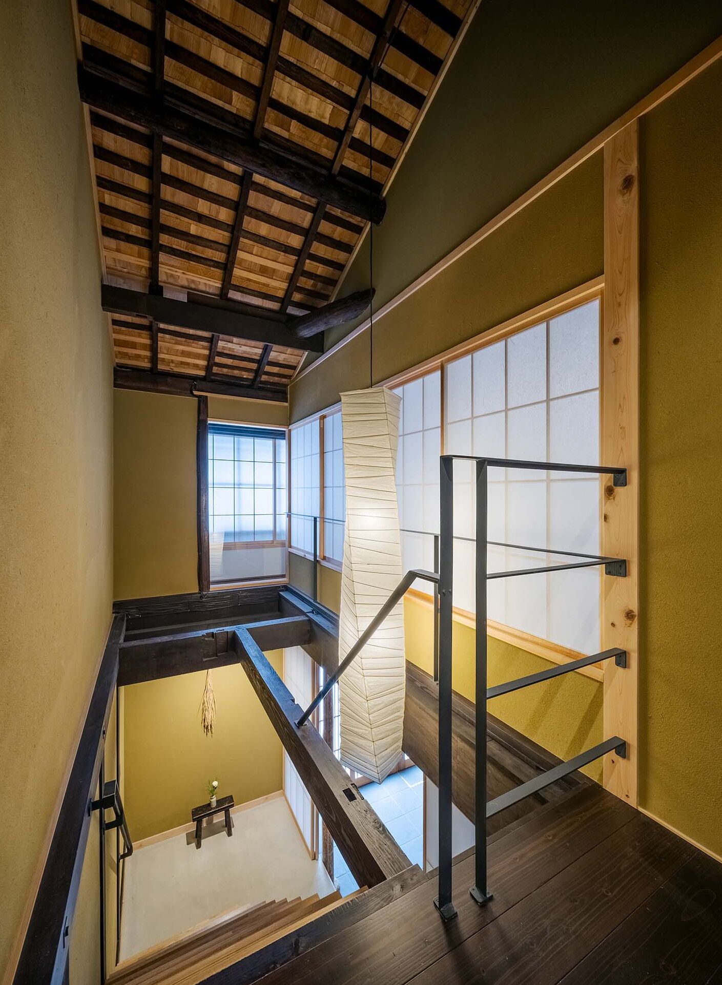 A traditional Japanese-style interior with tatami flooring, a wooden ceiling, and sliding shoji doors.