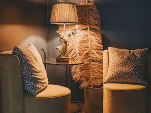 A room with two armchairs, a small round table, a lamp, and a decorative plant. - 4 Star Holiday Home in Hisings Backa (Hisings Backa)