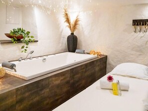 A modern bathroom with a large bathtub, a wooden vanity, and a wall-mounted towel rack. - 4 Star Holiday Home in Hisings Backa (Hisings Backa)