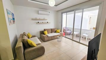 Apartment, City View | Living area | Flat-screen TV