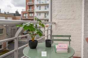 Enjoy a quiet moment on the balcony with a potted plant and a good book.