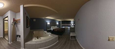 A modern bathroom with a bathtub, a shower, and a toilet.