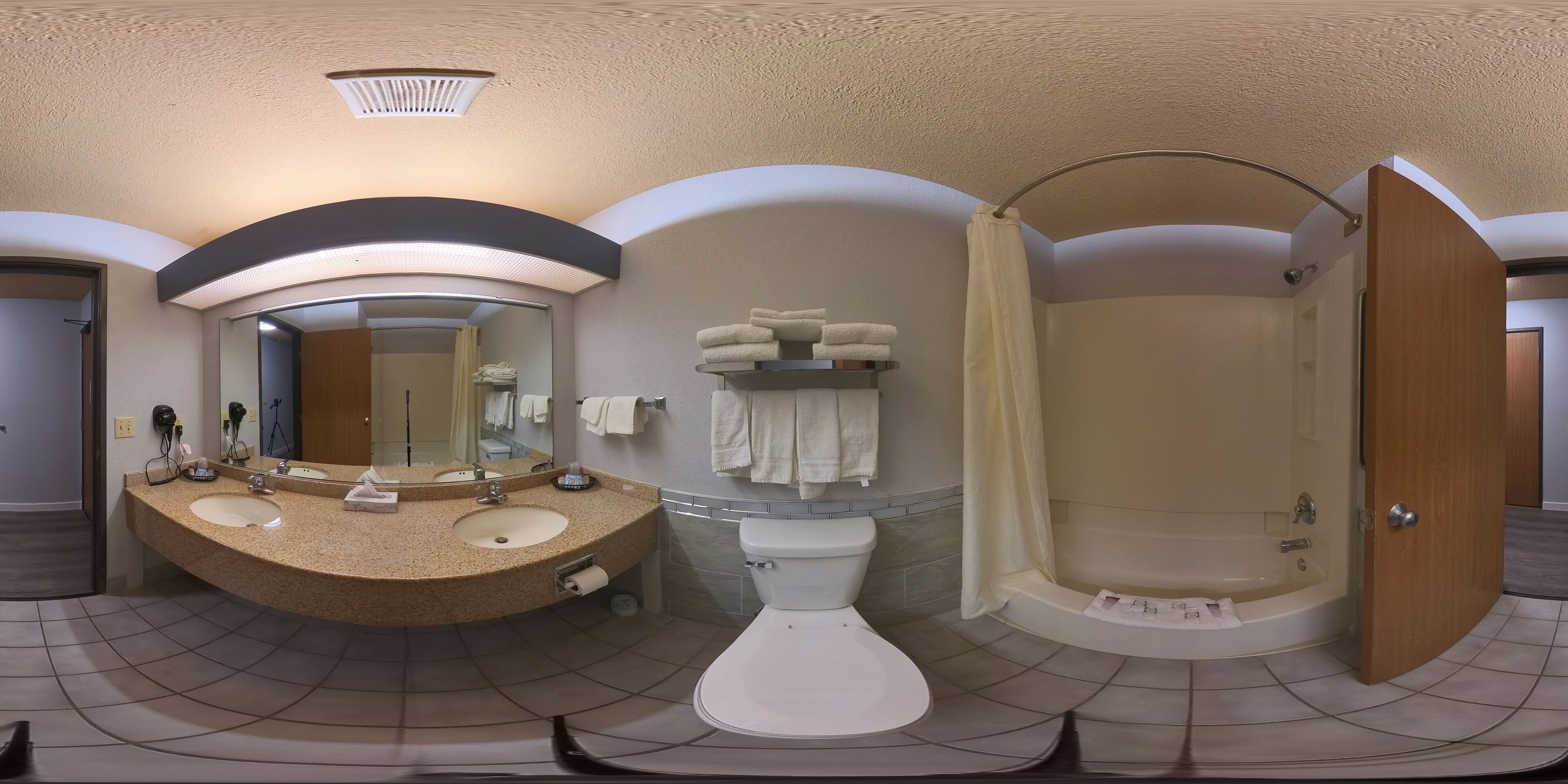 A bathroom with a sink, mirror, toilet, and shower.