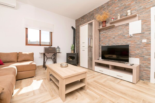 Relax in a cozy corner with a comfortable sofa and flat-screen TV.