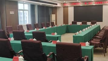 A conference room with a long table, chairs, and name placards.