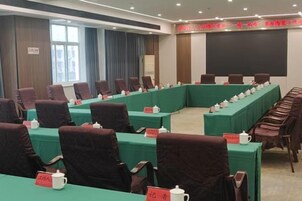 A conference room with a long table, chairs, and name placards.