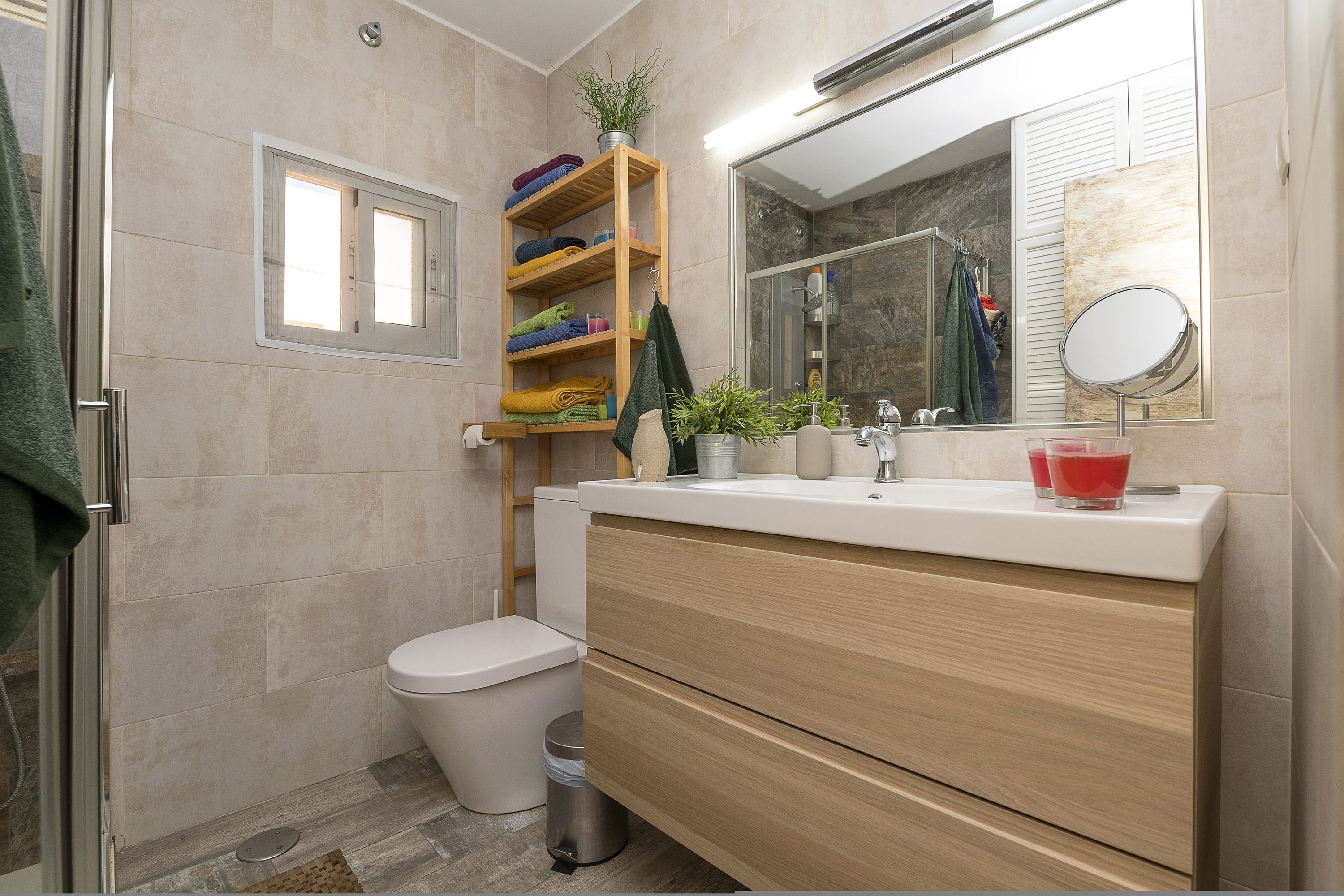 A modern bathroom with a toilet, sink, and shower.