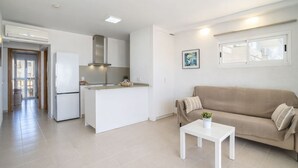 A modern apartment with a kitchen, living area, and a dining table. - Apartment Xisca by Interhome (Port d'Alcúdia)