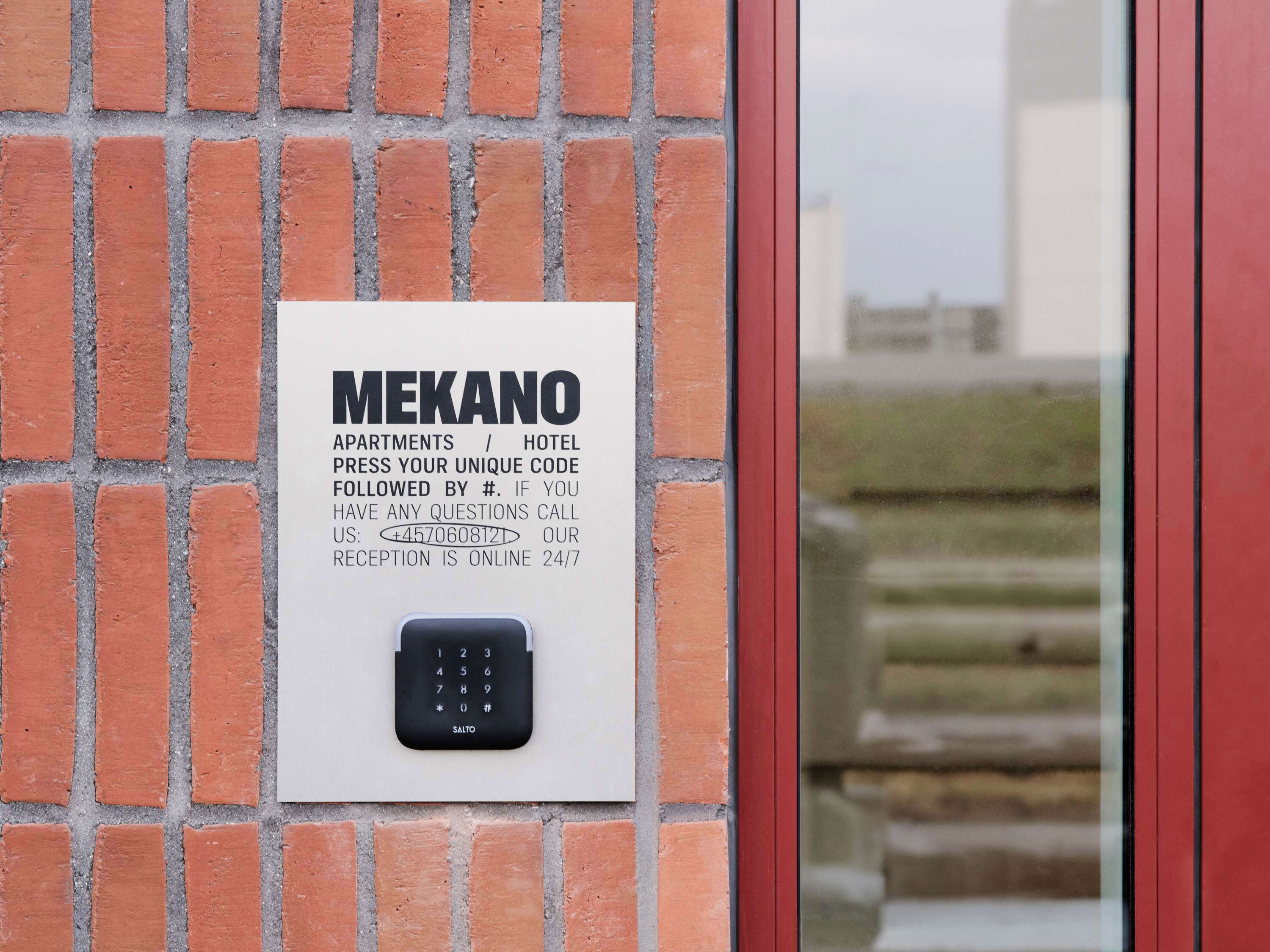 A wall-mounted keypad with instructions for a hotel or apartment.