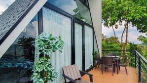 A modern villa with a glass conservatory, outdoor seating, and a hot tub. - Viewscape Nature Park Tanay powered by Cocotel (Tanay)