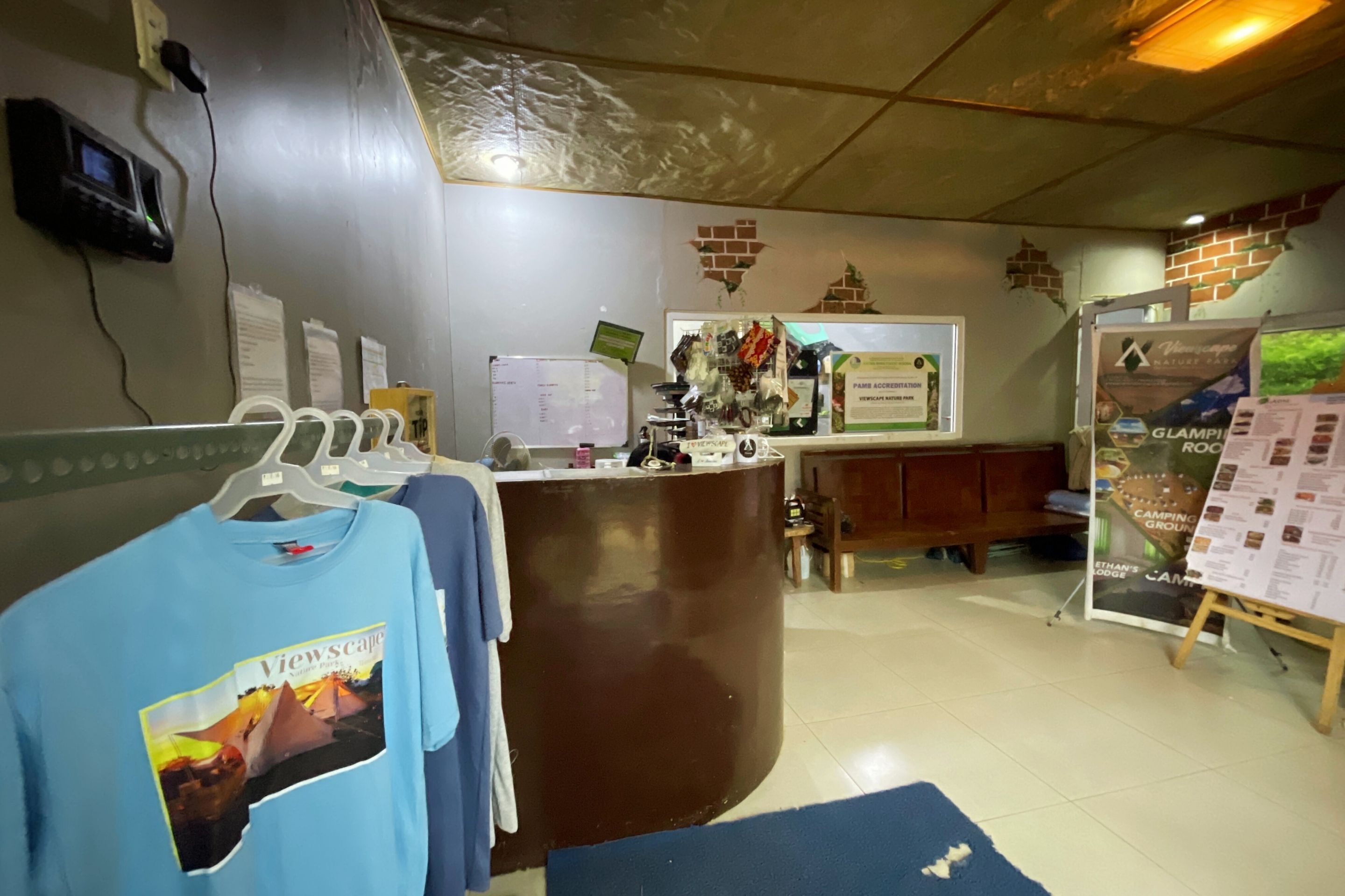 Un espace d’accueil comprenant un comptoir, un tableau d’affichage et un présentoir de brochures.
