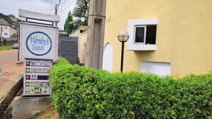 A sign for Wenby's Suites advertising accommodation, restaurant, bar, and banquet hall. - Wendy's Suites  (Abeokuta)