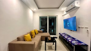 A modern living room with a sofa, a coffee table, and a bench. - 6-15 - 1 Bdr Condo With Balcony and Shared Pool (Patong)