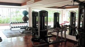 A gym with exercise equipment, a bench, and a rack of dumbbells. - 6-15 - 1 Bdr Condo With Balcony and Shared Pool (Patong)