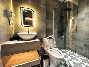 A modern bathroom with a sink, toilet, and shower. - Phuoc Hung 3 (Long Chau)