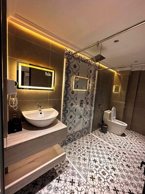 A modern bathroom with a large mirror, two sinks, a toilet, and a shower. - Phuoc Hung 3 (Long Chau)