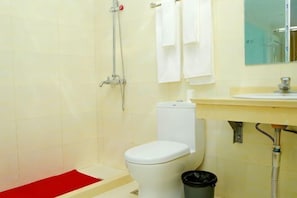 A bathroom with a white toilet, a shower, a sink, and a mirror. - Zhouzhuang Holiday Hostel (Kunshan)