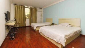 A hotel room with two beds, a desk, a chair, a TV, and a window with curtains. - Zhouzhuang Holiday Hostel (Kunshan)