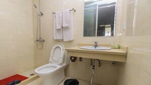 A bathroom with a toilet, a shower, a sink, and a mirror. - Zhouzhuang Holiday Hostel (Kunshan)