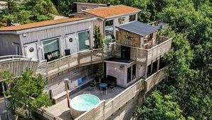 A multi-story building with a rooftop pool, balconies, and a wooden deck. - 4 Star Holiday Home in Hisings Backa (Hisings Backa)