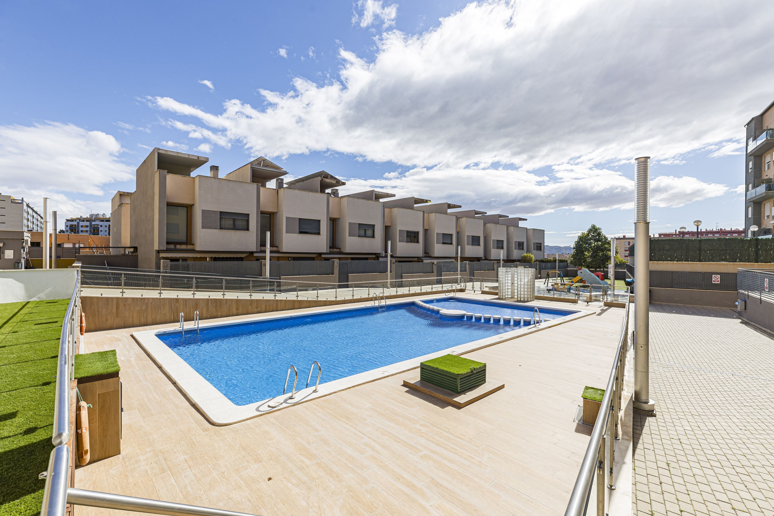 A rooftop swimming pool with a clear view of the surrounding buildings.