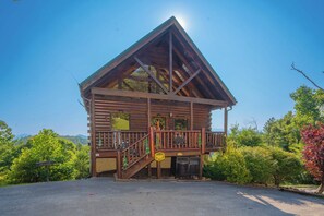 Enjoy a scenic view of the surrounding forest from the upper level balcony.