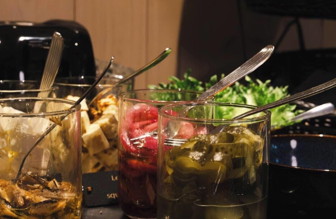A table with various food items and utensils.