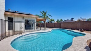 A swimming pool with a curved edge, surrounded by a concrete deck. - Charming 3-bedroom house with AC, WiFi in fabulous Glendale (Glendale)