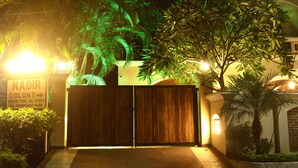 A gated entrance with a sign for "NADIR COLONY" and a house number. - Suramya (Bhopal)