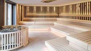 A modern spa area with wooden benches and a circular seating area.