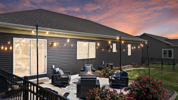 A residential house with a patio area featuring outdoor furniture, a fire pit, and string lights. - 25min to Capitol - KING Suite - Game Room - Groups (Stoughton)