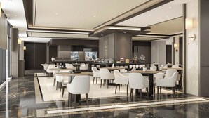 A modern dining area with marble flooring, white chairs, and a central buffet.