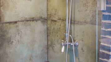 A shower with a handheld showerhead and a handheld sprayer.