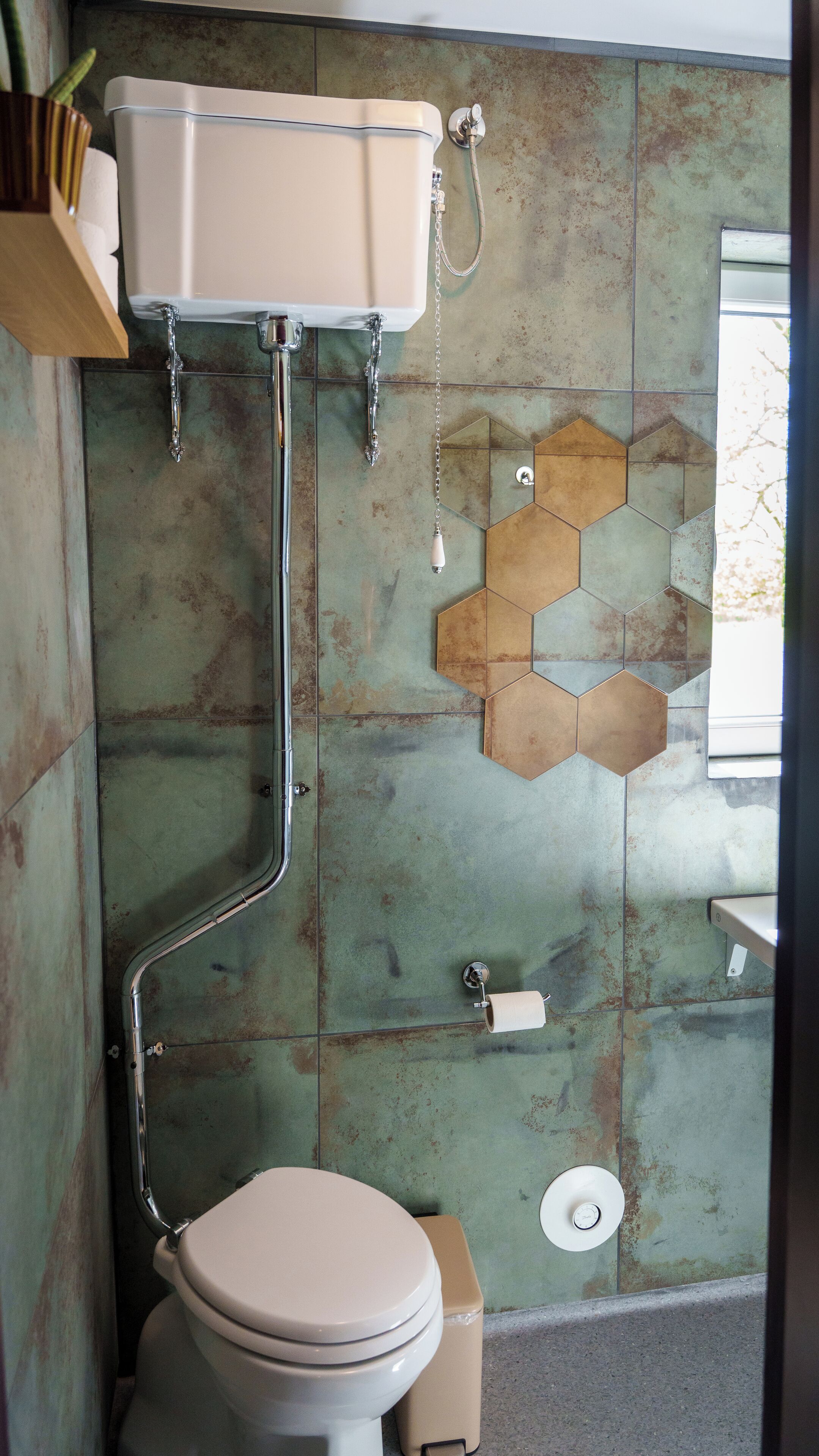 A bathroom with a toilet, a sink, and a shower.