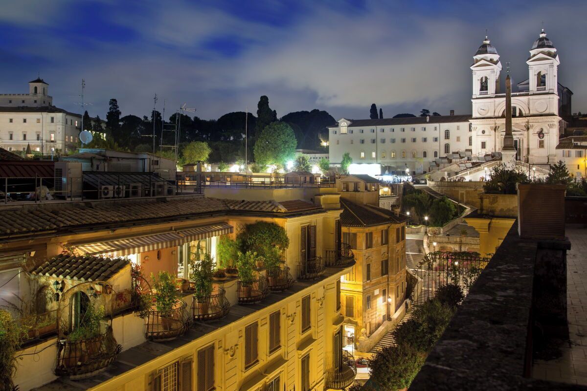 A historic town square with a prominent church and a bell tower, surrounded by traditional buildings and a canal.