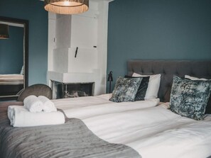 A bedroom with a bed, a fireplace, and a mirror. - 4 Star Holiday Home in Hisings Backa (Hisings Backa)