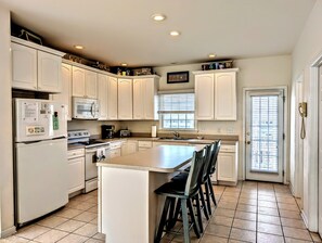Fridge, stovetop, dishwasher, coffee/tea maker