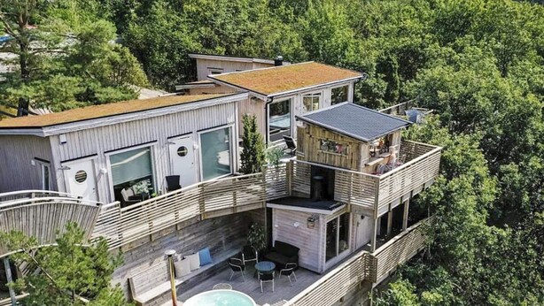 A modern multi-story house with a rooftop pool, large windows, and a balcony with outdoor seating. - 4 Star Holiday Home in Hisings Backa (Hisings Backa)