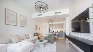 A modern living room with a sofa, coffee table, and artwork on the wall.