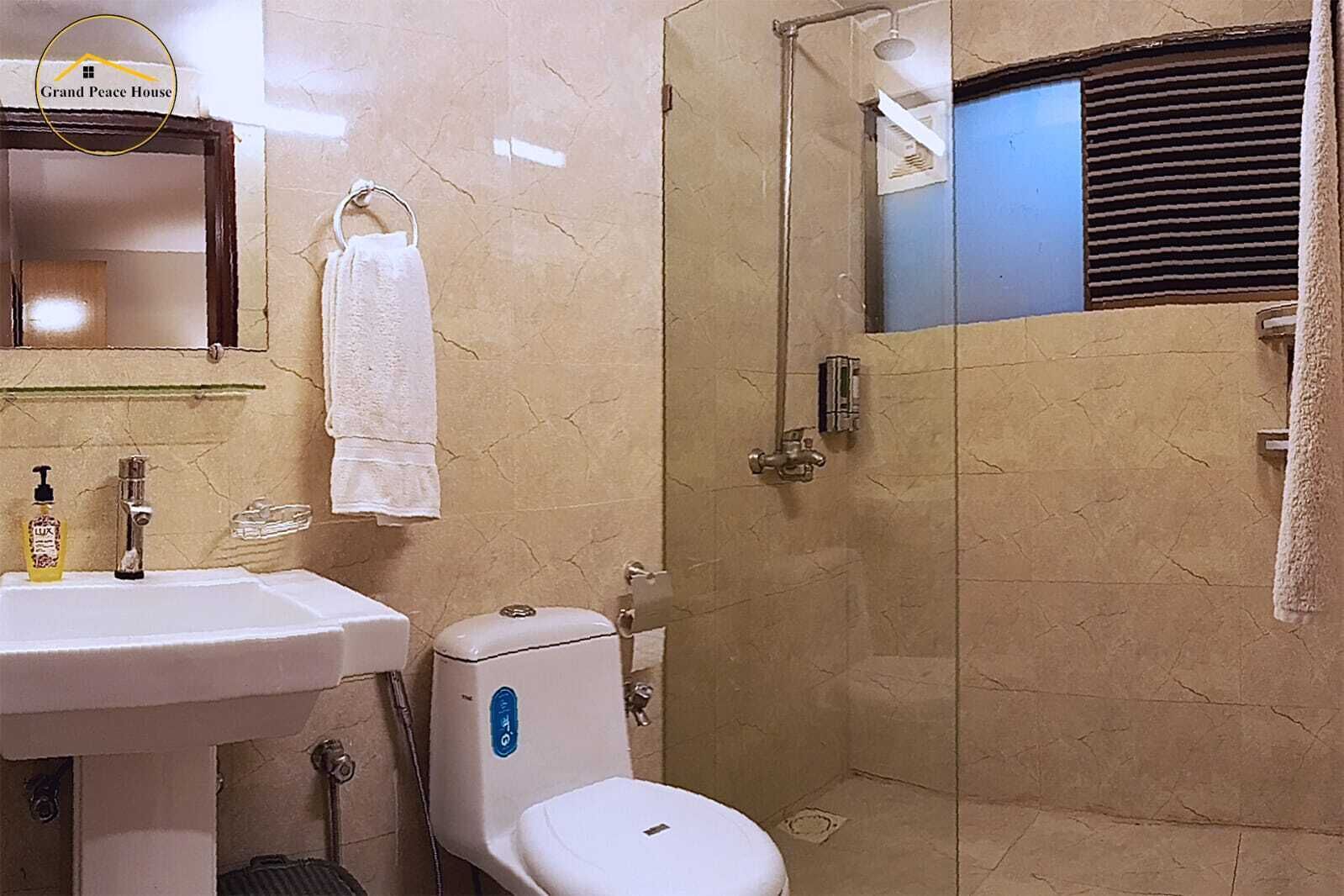 A bathroom with a sink, toilet, and shower.
