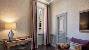 A hotel room with a desk, chair, and a sofa with decorative pillows. - The Inn at the Spanish Steps Elegant Collection - The Jewel (Rome)