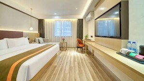 A hotel room with a bed, a desk, a chair, a TV, and a window with curtains. - GYA Hotel (Jiaxing Nanhu Scenic Area Nanhu Tiandi) (Jiaxing)